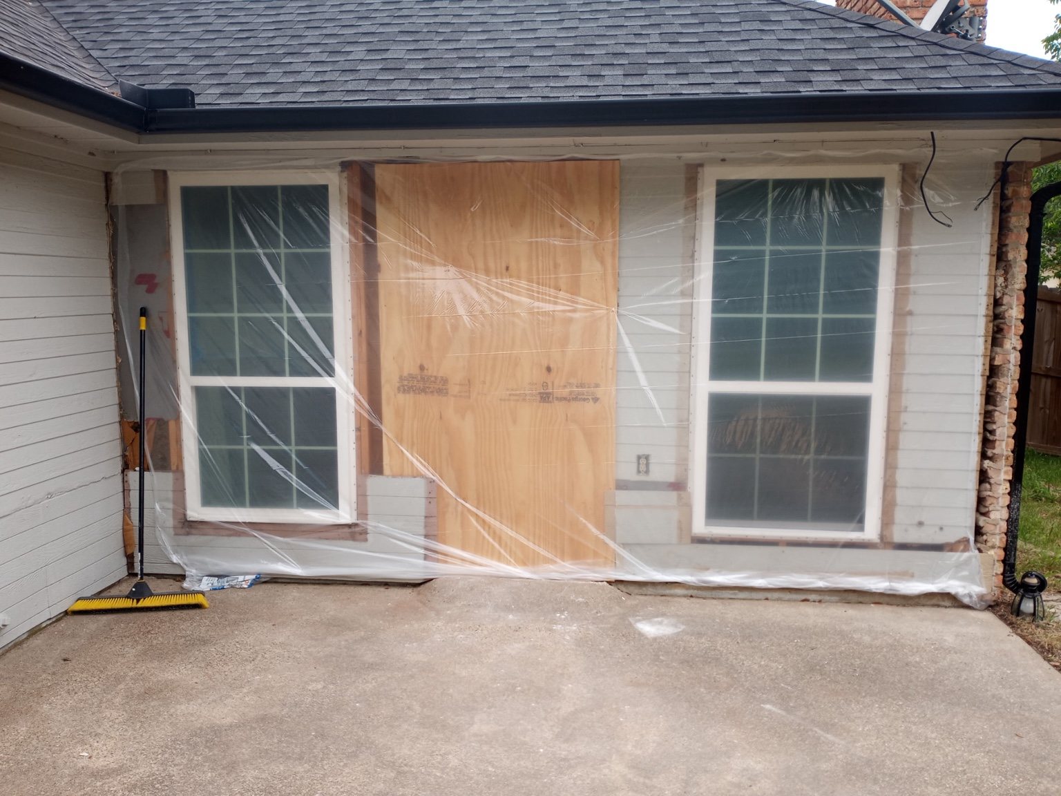Termite-damaged exterior door area before restoration